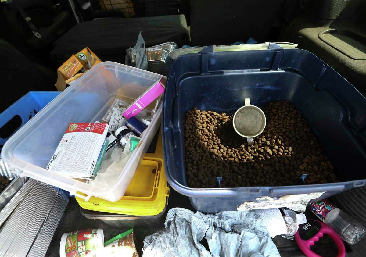 Dog food, hear worm and flea medicine is seen in the back of the vehicle of a K-911 animal rescue volunteer May 15, 2022 in Houston.
