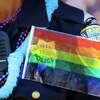 Police officer Christine Magazines wears a flag over her police pin, during the 46th annual LGBT Pride Parade, in San Francisco, California, on Sunday, June 26, 2016. San Franscisco police officers decided not to march in the 2022 Pride parade after being asked to refrain from wearing their uniforms while marching at the event.