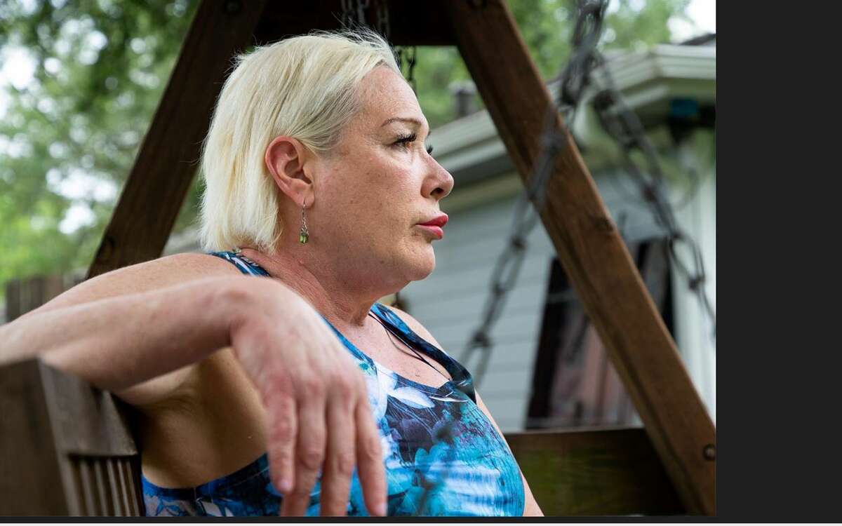 Linda Ferriulo, 62, poses for a photograph in her backyard on Friday, May 20, 2022, in Houston. After 25 years as a massage therapist, Ferriulo had her massage therapist license revoked when the Texas Department of Licensing and Regulation sent her a letter in 2020.