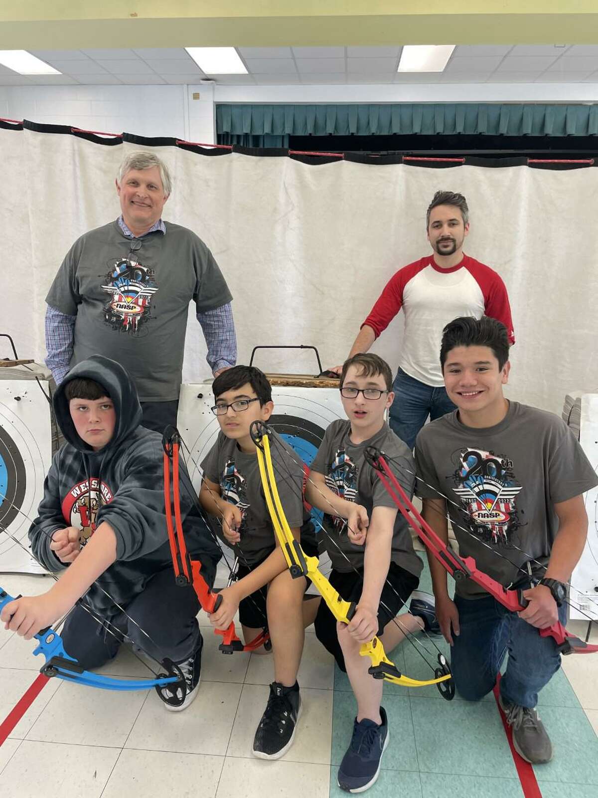 The West Shore Middle School Archery Club members representing the school at last weekend’s Eastern National Championships are, left to right, Jacob LeClaire, Yusuf Genc, David Hancock, and Santiago Penagos. Club advisors David Zunski and Marcus Blair are pictured behind the archers.