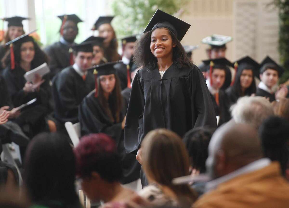 Graduate and first-time-ever two-time winner of the Head of School Award Rory Ashmeade walks up to receive her diploma at the Greenwich Country Day School commencement in Greenwich, Conn. on Friday, May 20, 2022. Ashmeade will attend Yale University.