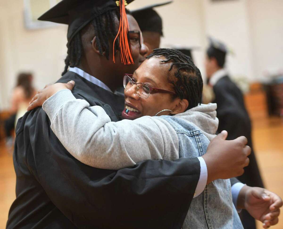 Graduate Jamaal DeGraffenried Jr. is hugged by his great aunt, Stephanie Snell, both of Stamford.
