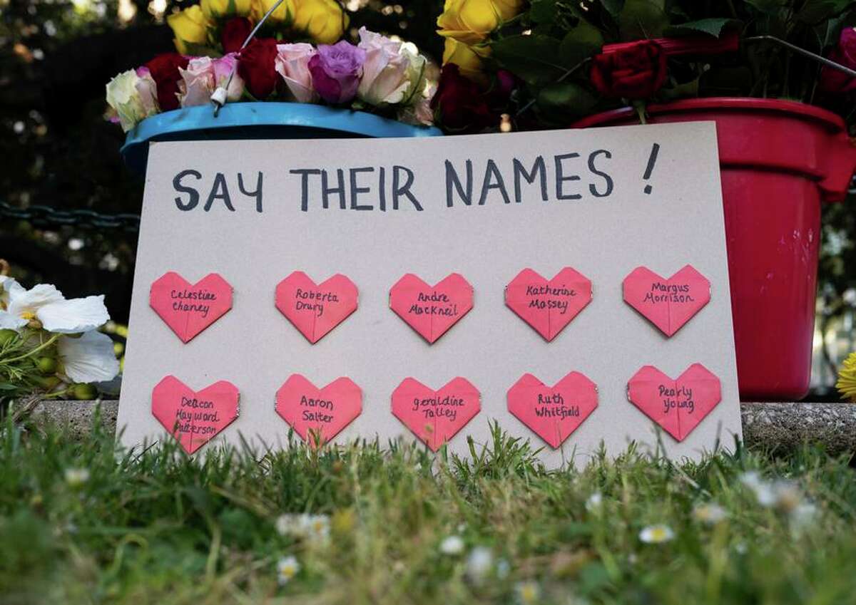 A sign at the Oakland vigil honors the names of the 10 people killed in the mass shooting in Buffalo, N.Y.