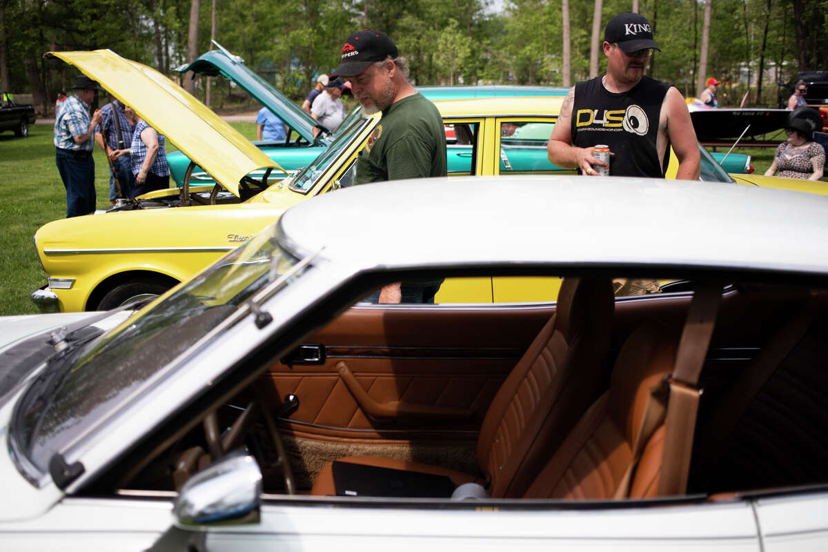 Chris Thornton, left, and David Taylor, right, attend the Sanford Rising Car Show on Friday May 20, 2022 at Porte Park.