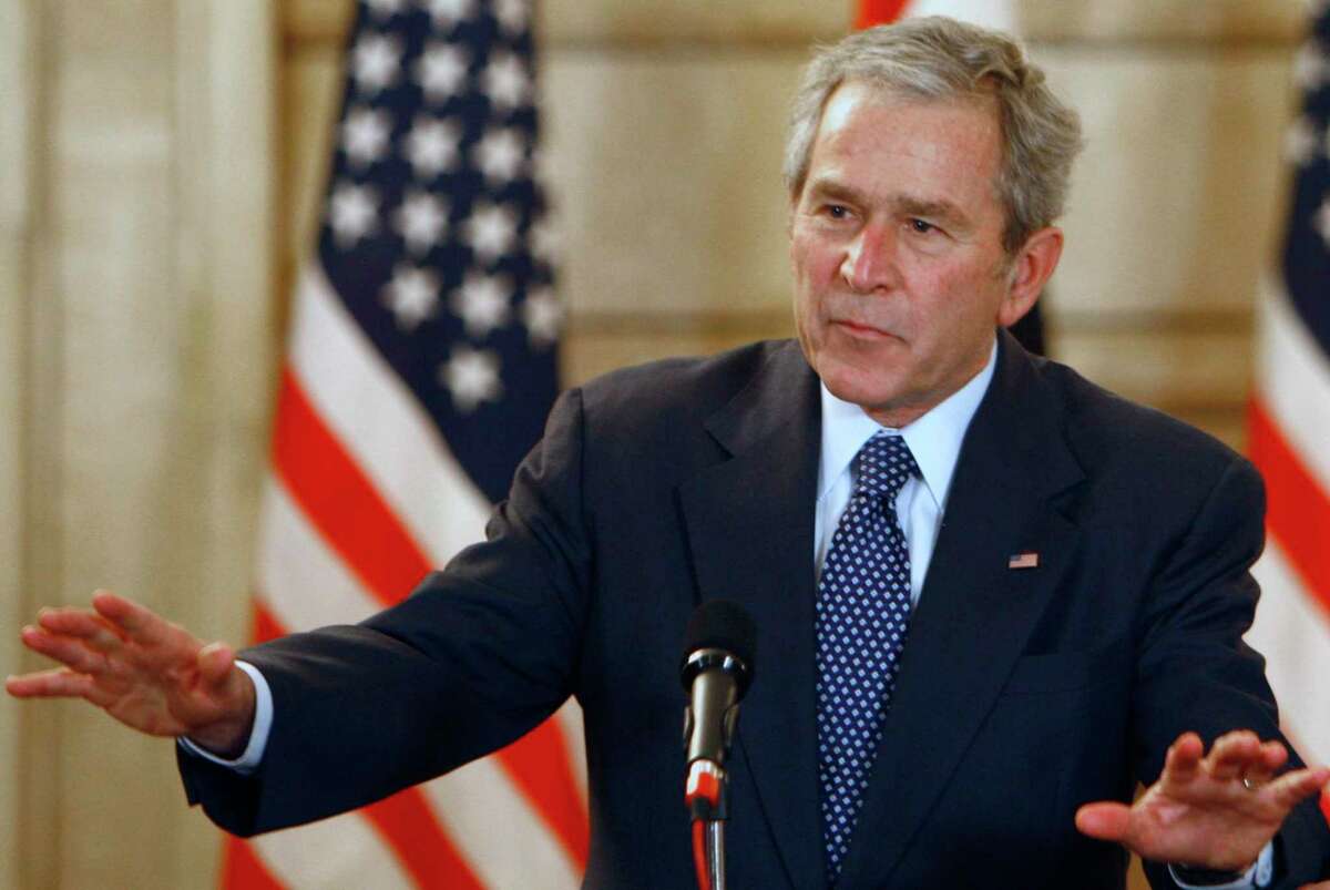 FILE - U.S. President George W. Bush, reacts, after shoes were thrown at him, by a correspondent, during a joint press conference with Iraq Prime Minister Nouri al-Maliki, not seen, in Baghdad, Iraq, Dec. 14, 2008. Bush is facing criticism after mistakenly describing the invasion of Iraq — which he led as commander in chief — as “brutal” and “wholly unjustified,” before correcting himself to say he meant to refer to Russia’s invasion of Ukraine. He added, “Iraq, too — anyway.” The 75-year-old former president made the comment during a speech Wednesday night in Dallas, jokingly blamed the mistake on his age. (AP Photo/ Thaier al-Sudani, Pool, File)