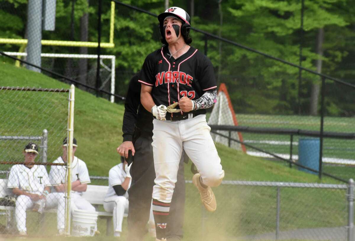 Fairfield Warde's Zach Broderick celebrates after sliding safely into home during a baseball game between Trumbull and Fairfield Warde at Trumbull High, Trumbull on Friday, May 20, 2022.