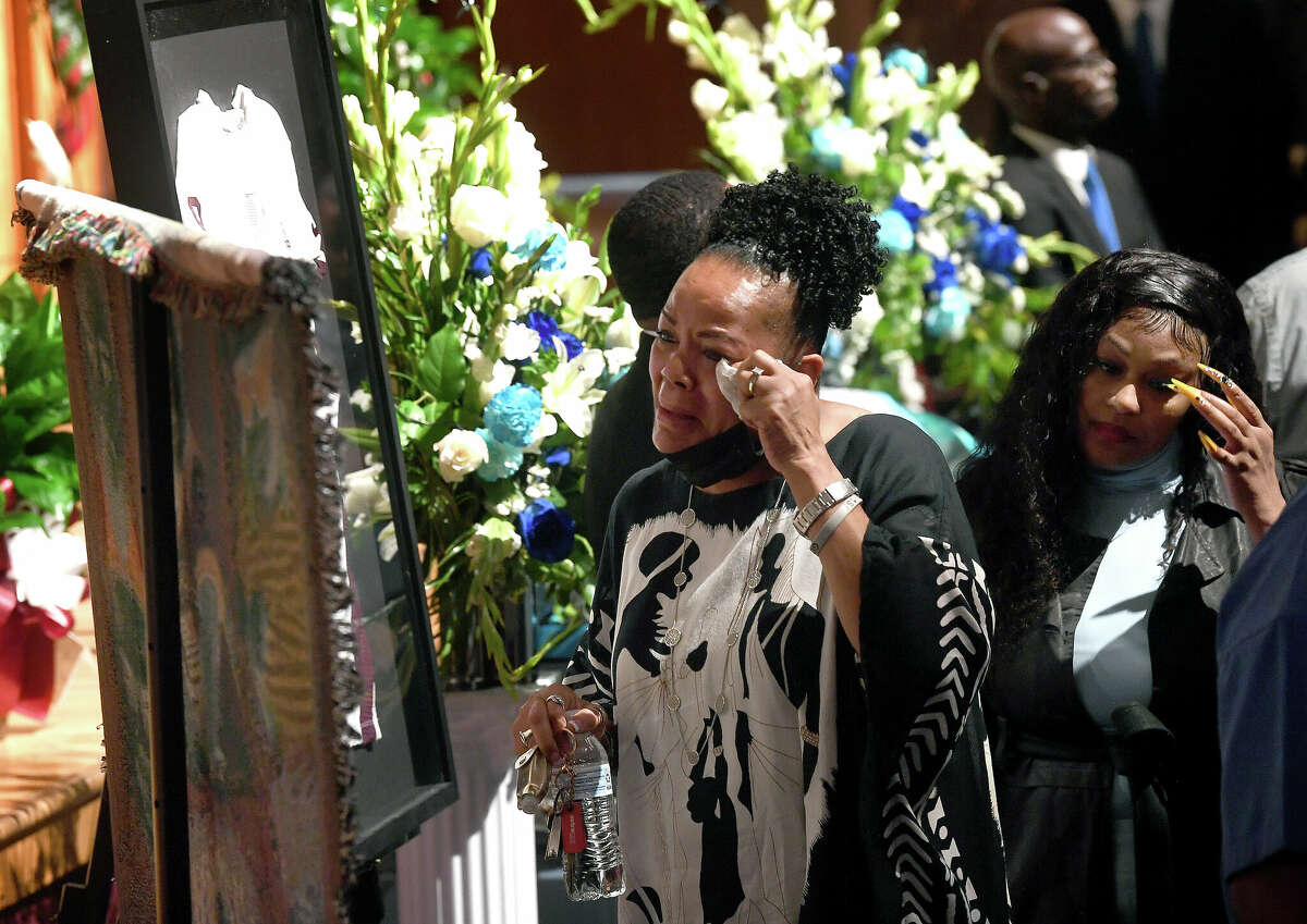 Family react as they process in past the casket and photos during a memorial service commemorating the life of 17-year-old Silsbee student and athlete Jayce Jones, who passed away last Thursday after battling brain cancer. Photo made Friday, May 20, 2022. Kim Brent/The Enterprise