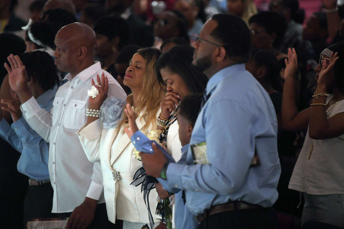 The family joins the gathering in prayer during a memorial service commemorating the life of 17-year-old Silsbee student and athlete Jayce Jones, who passed away last Thursday after battling brain cancer. Photo made Friday, May 20, 2022. Kim Brent/The Enterprise
