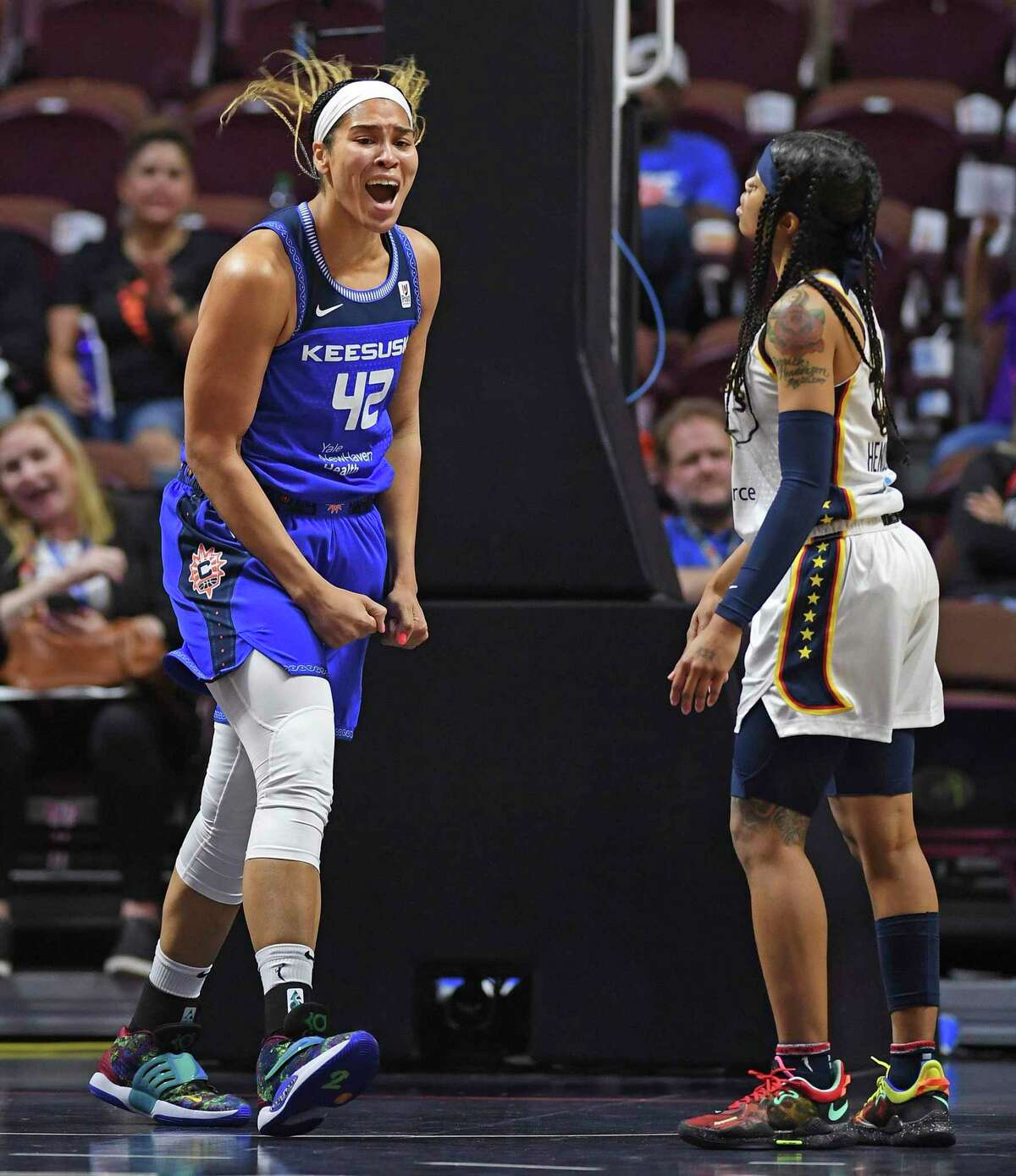 Connecticut Sun center Brionna Jones (42) celebrates after she was fouled while making a basket against the Indiana Fever, next to Fever guard Destanni Henderson (33) during a WNBA basketball game Friday, May 20, 2022, in Uncasville, Conn. (Sean D. Elliot/The Day via AP)