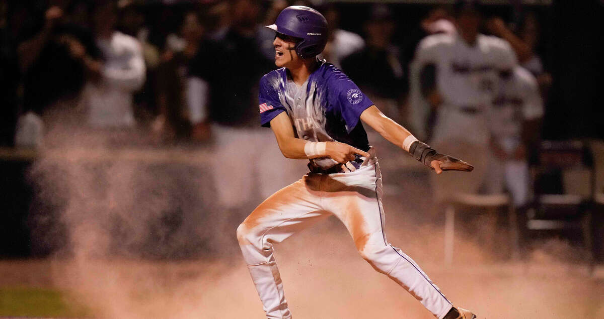 Ridge Point's Owen Farris signals himself safe after scoring a run during the sixth inning of Game 2 of a Region III-6A quarterfinal high school baseball playoff series against Tompkins, Friday, May 20, 2022, in Katy, TX.