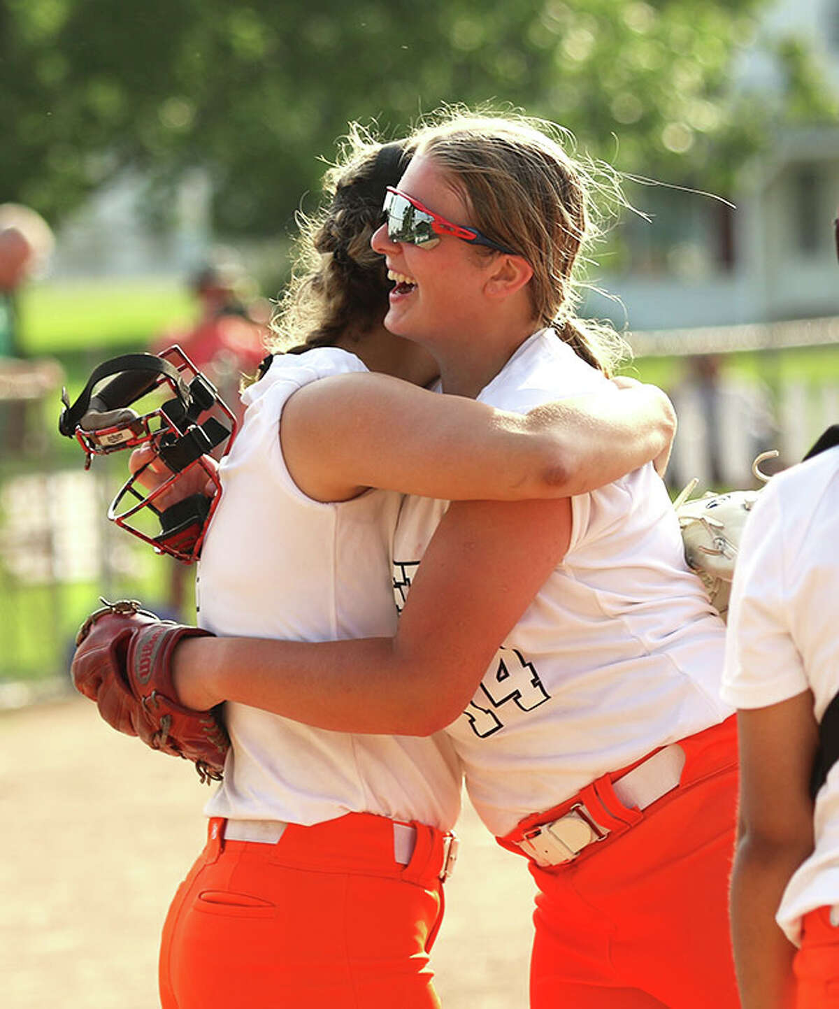 Gillespie pitcher Emma Gipson (left) and third baseman Regan Bussmann celebrate after the final out in the Miners' win over Robinson on Friday in the Salem Class 2A Regional.