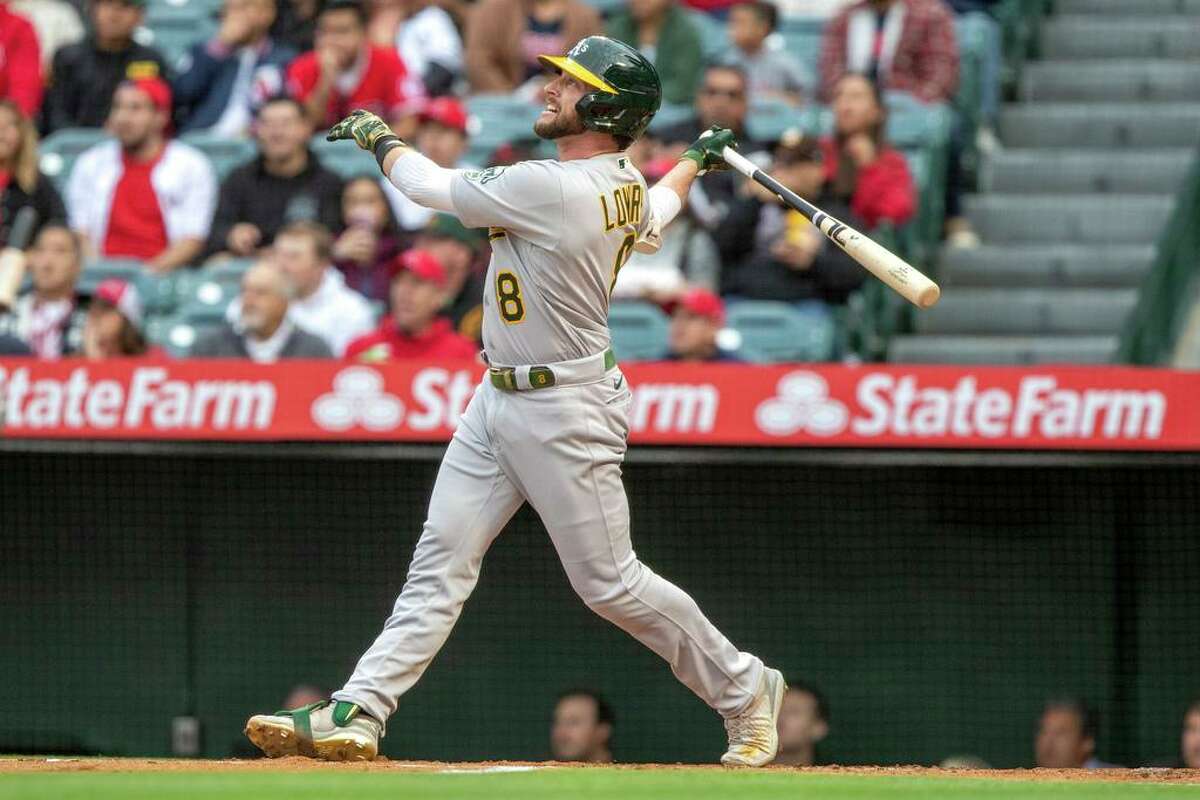 Oakland Athletics' Jed Lowrie follows through on a solo home run against the Los Angeles Angels during the first inning of a baseball game in Anaheim, Calif., Friday, May 20, 2022. (AP Photo/Alex Gallardo)