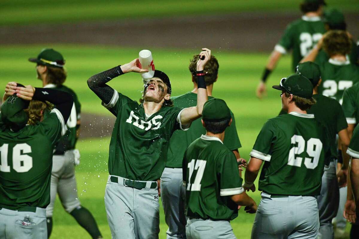 Jordan Buske of Reagan pours a drink on himself in celebration after they defeated Smithson Valley in Class 6A regional quarterfinal playoffs action at North East Sports Park on Friday, May 20, 2022.