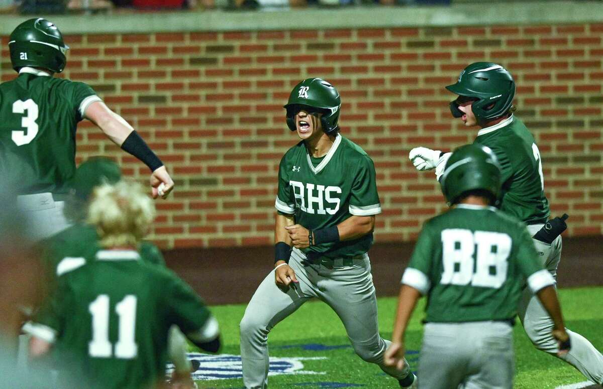 Jacob King of the Reagan Rattlers celebrates with teammates after scoring what would be the game-winning run against Smithson Valley during Class 6A regional quarterfinal playoffs at North East Sports Park on Friday, May 20, 2022. The final was 3-2.
