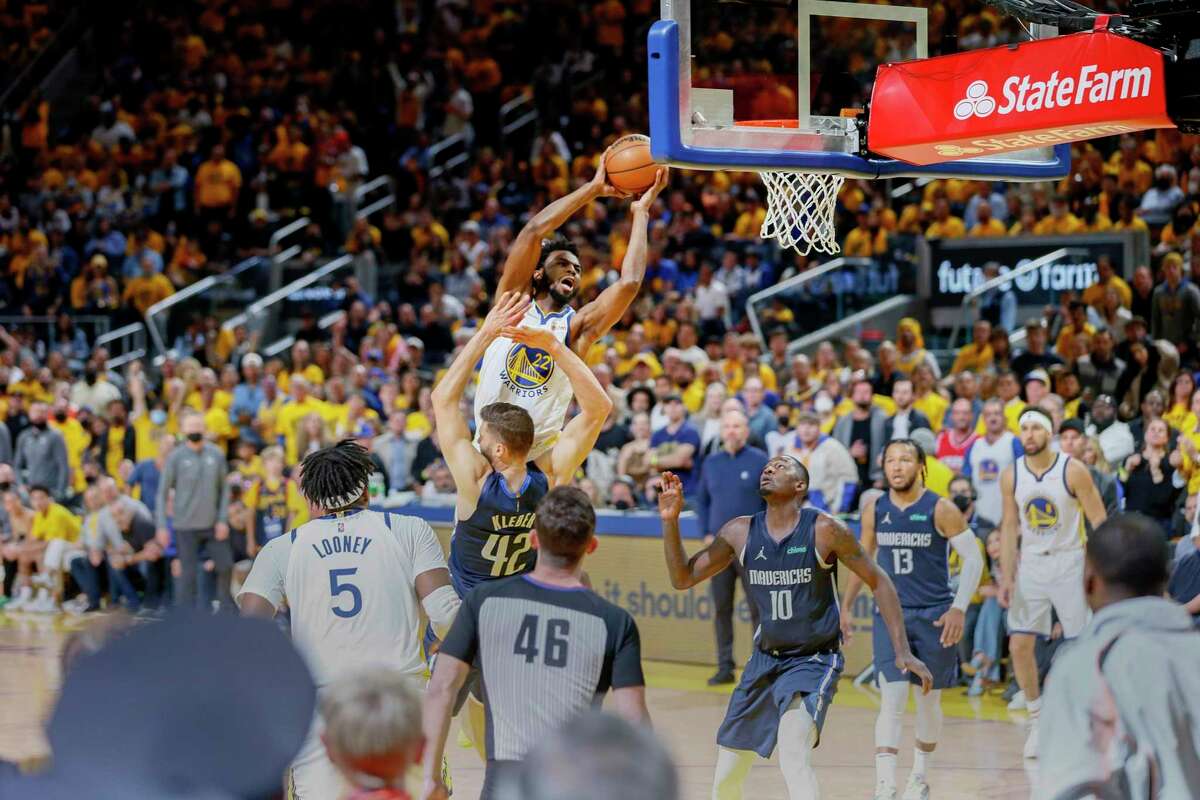 Golden State Warriors forward Andrew Wiggins (22) is fouled as he drives to the hoop during the third quarter in Game 2 of the Western Conference finals against the Dallas Mavericks at Chase Center, Friday, May 20, 2022, in San Francisco, Calif.