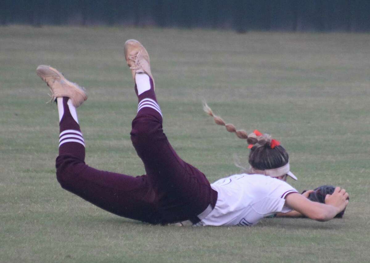 Deer Park outfielder Loreli Graham pulls off a terrific sliding catch in the third inning Friday night. It was one of only two balls that left the infield all night long by Seven Lakes batters.