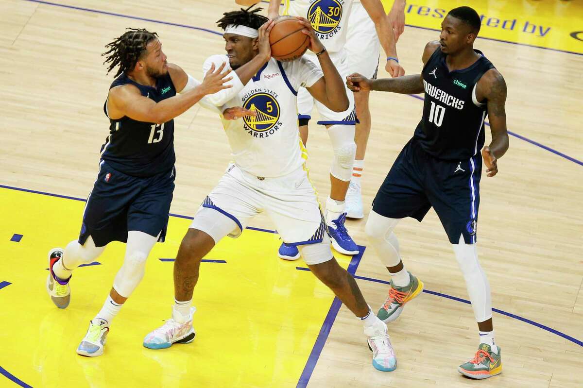 Golden State Warriors center Kevon Looney (5) grabs the rebound and looks to pass during the fourth quarter in Game 2 of the Western Conference finals against the Dallas Mavericks at Chase Center, Friday, May 20, 2022, in San Francisco, Calif.