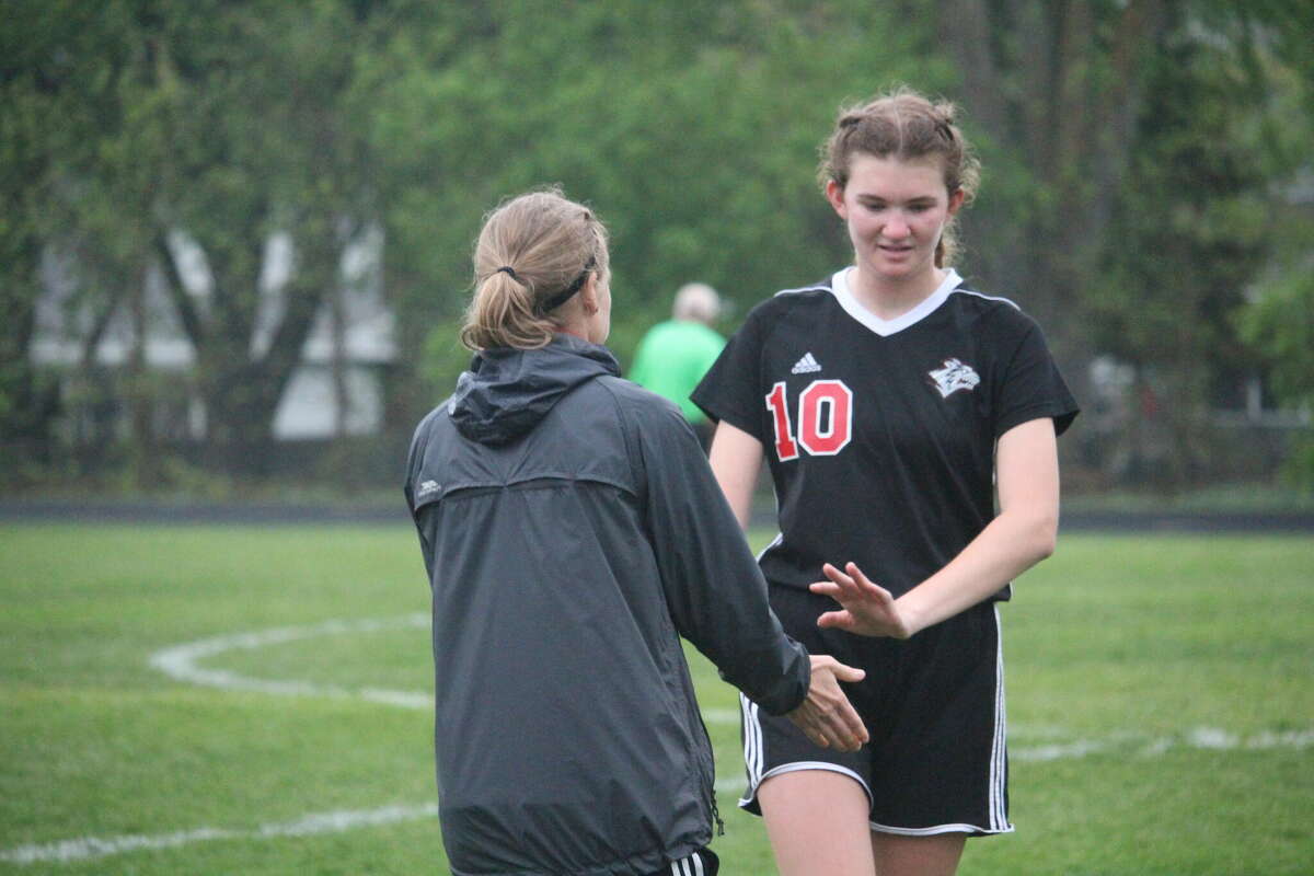 Reed City coach Andrea Pollaski (left) thanks Nora Smoes for her efforts during Friday's 5-2 loss to Grant.