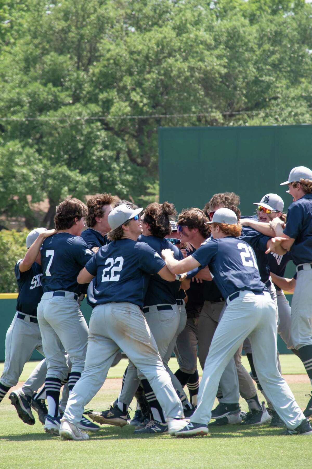 The Second Baptist School baseball players mob each other around the pitcher's mound after getting the final out in an 11-5 victory over Brook Hill in the TAPPS Division II state championship game on the afternoon of May 19 at Clay Cloud Ballpark on the campus of the University of Texas at Arlington.