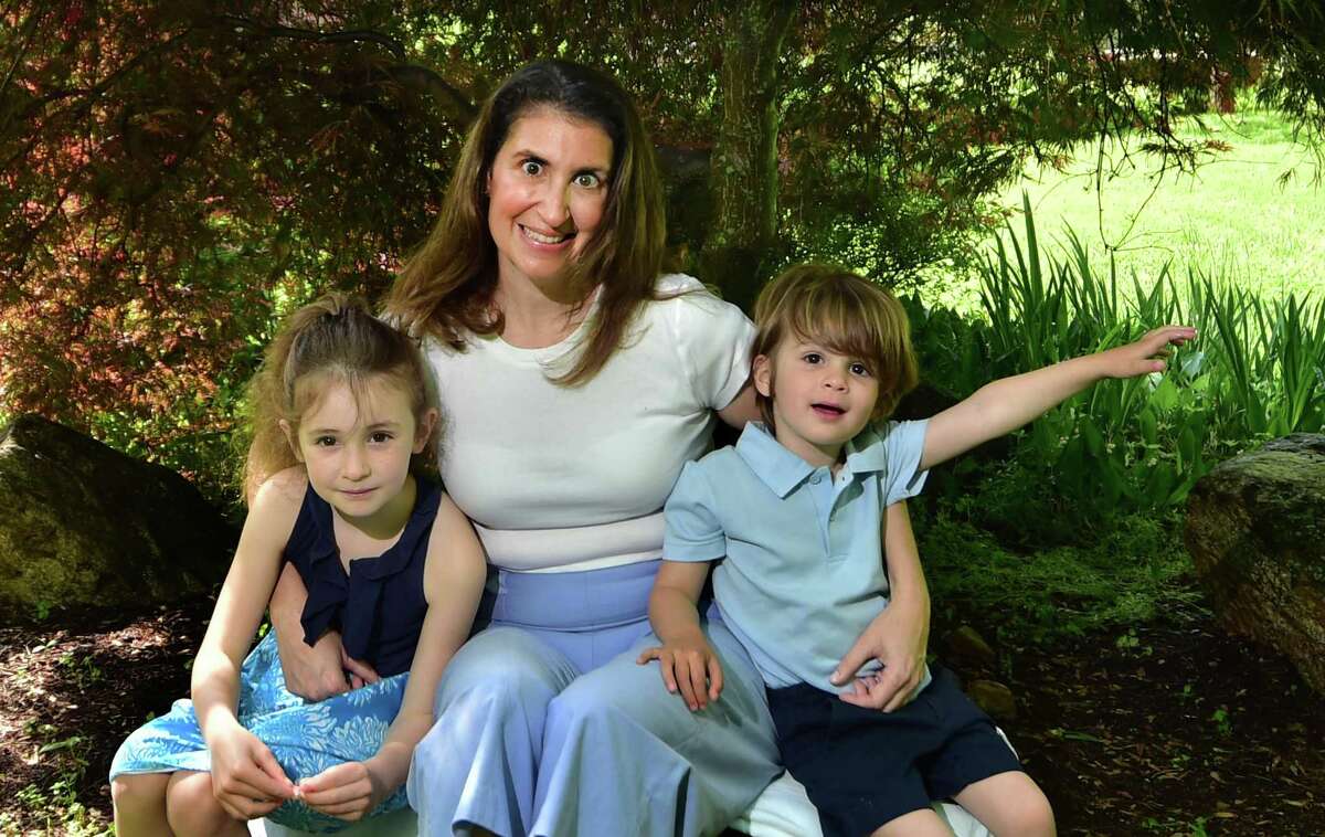 Cassie Mecsery poses with her children Calista and Westley Stephen at their home in Darien, Conn., on Saturday May 21, 2022. Cassie's husband Sean died recently after a two-year battle with an aggressive form of brain cancer. Sean, who was a Darien native, was the owner of Greenwich-based Cos Cob TV and Audio. Cassie is continuing to run the store, which first opened in 1945.