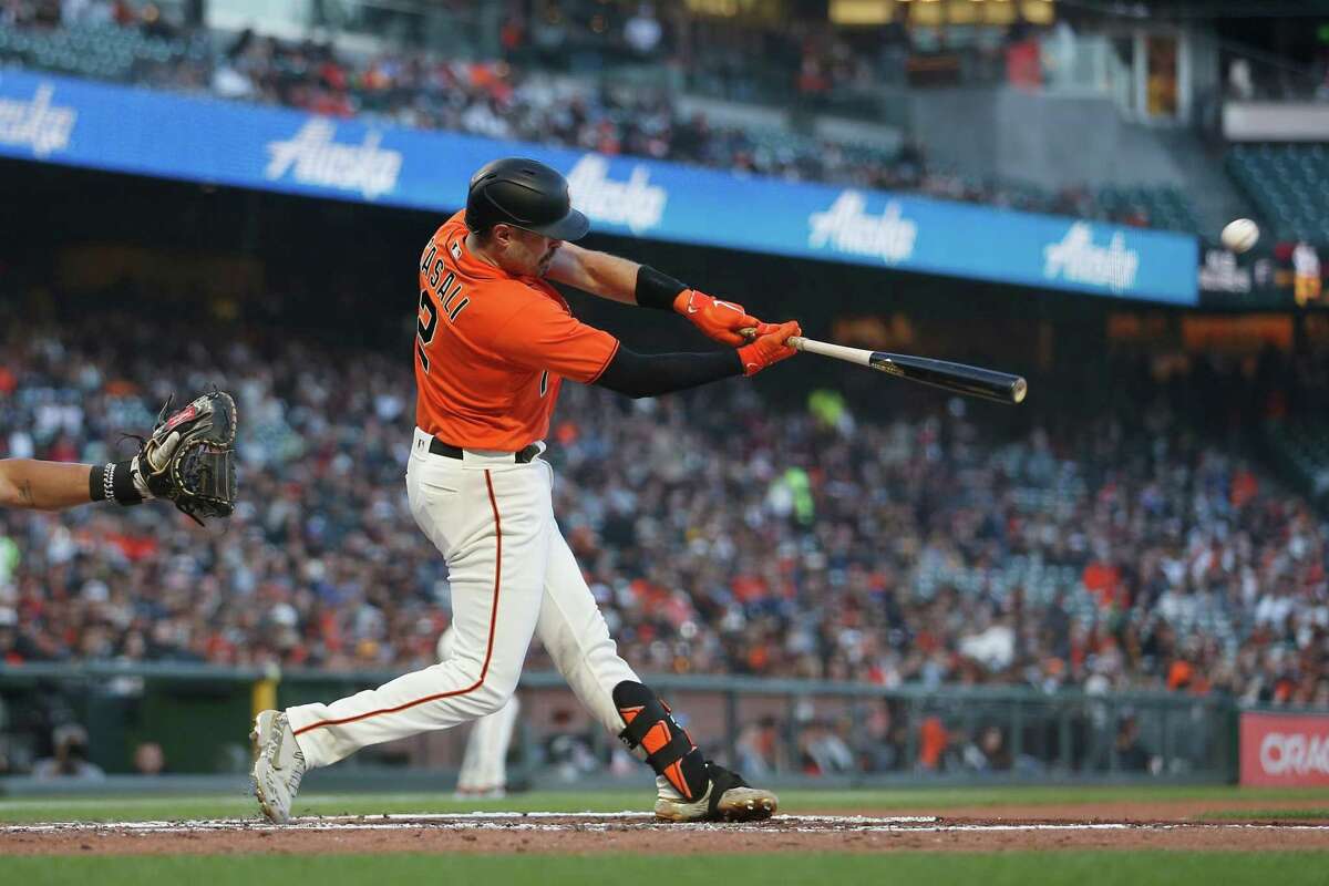 SAN FRANCISCO, CALIFORNIA - MAY 20: Curt Casali #2 of the San Francisco Giants hits an RBI sacrifice fly ball in the bottom of the second inning against the San Diego Padres at Oracle Park on May 20, 2022 in San Francisco, California. (Photo by Lachlan Cunningham/Getty Images)