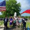 The Girl Scouts of Norwalk helped place flags on veterans' gravesites on Saturday at St. John's Cemetery in Norwalk on Saturday, May 21, 2022.