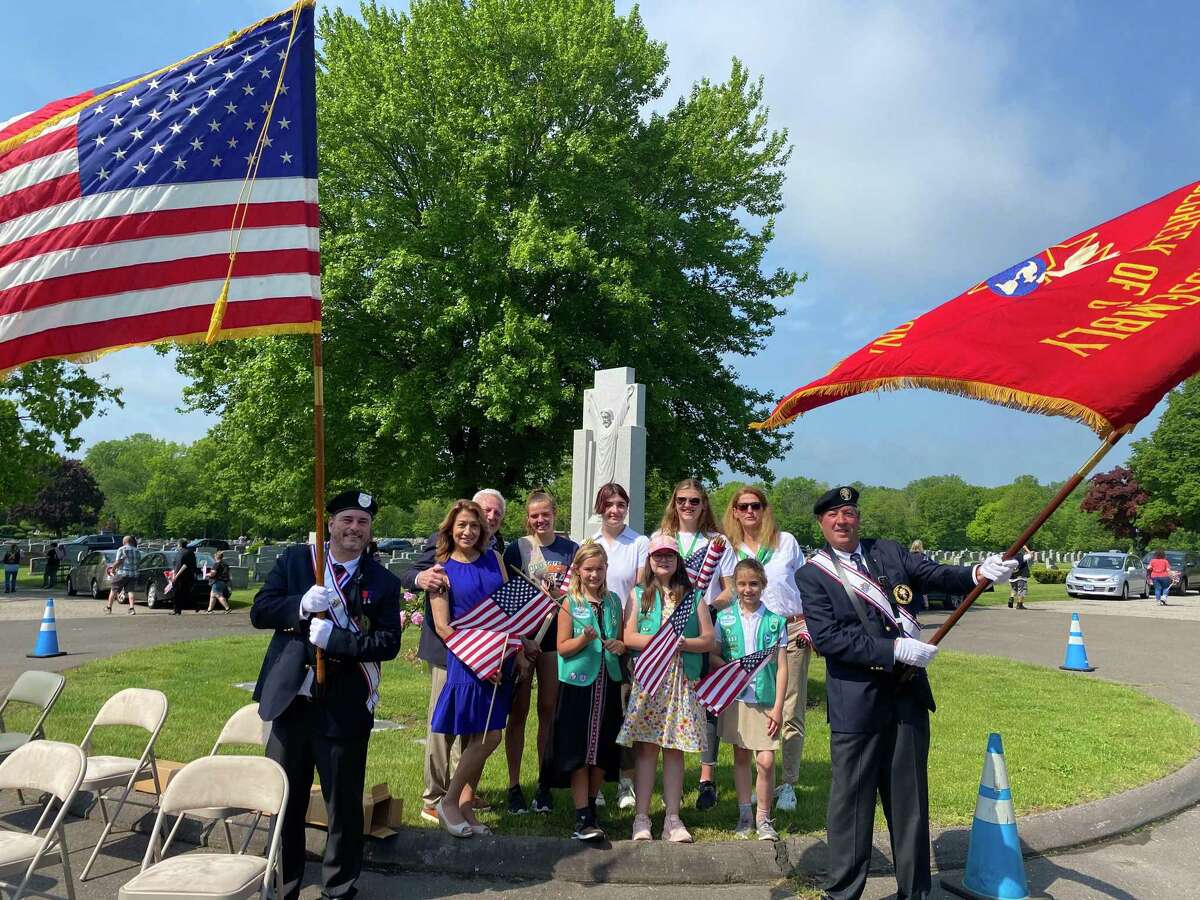 The Girl Scouts of Norwalk helped place flags on veterans' gravesites on Saturday at St. John's Cemetery in Norwalk on Saturday, May 21, 2022.