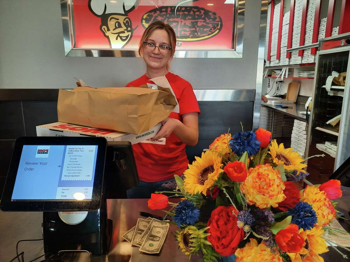 Godfrey Imo's server Mary McKeever, who was working with co-owner Tom Shereck on Mother's Day, happily delivers the Mother's Day Special to go. Imo's always has a special going.