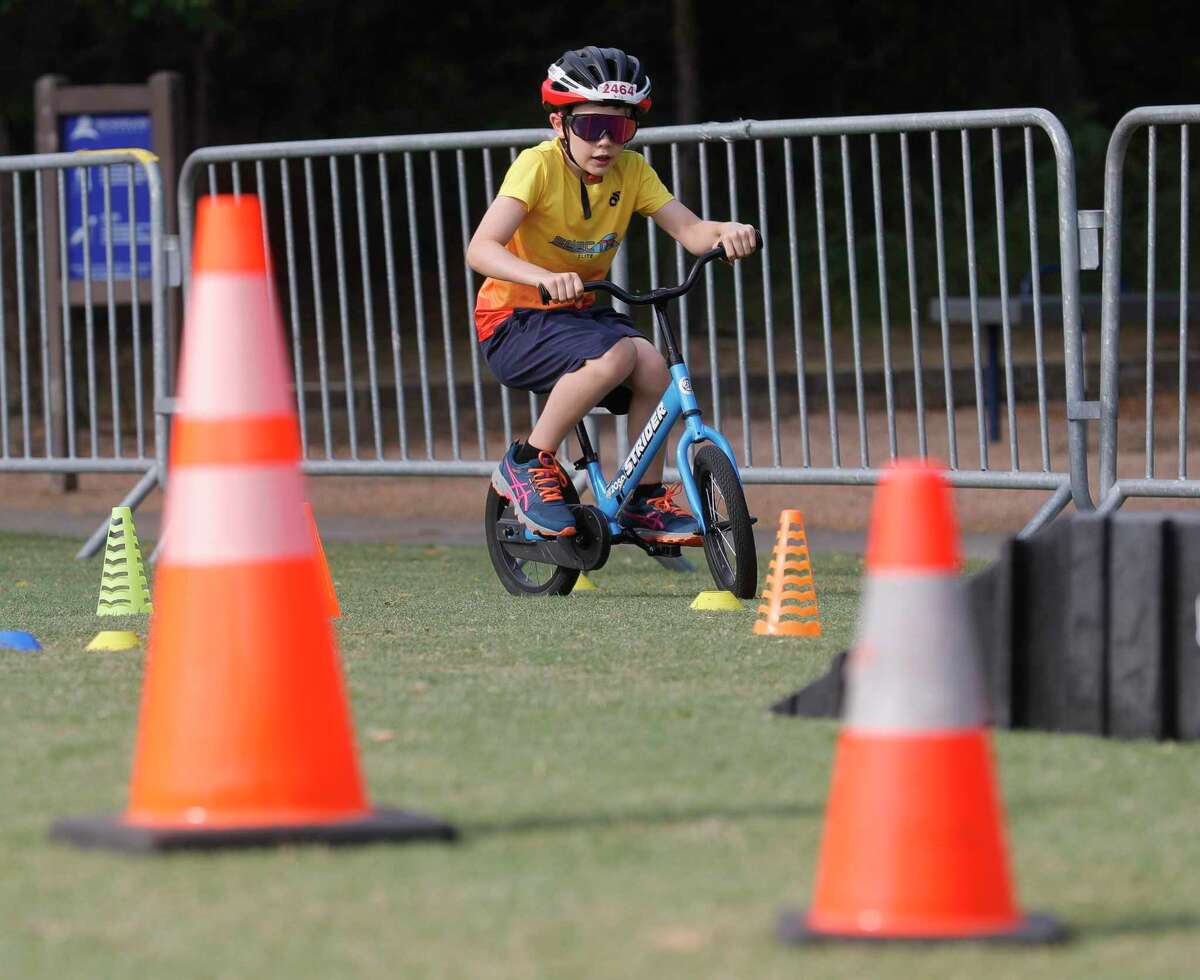 Sebastian Bianchi rides his bike through an obstacle course during the annual Bike The Woodlands event at Northshore Park, Saturday, May 21, 2022, in The Woodlands. The event featured exhibitors, including local bike shops, bicycle clubs and other supporters of Bike Month, as well as bike safety information.