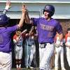 Westhill’s Connoor Sullivan high-fives Nico Christon after scoring during an FCIAC baseball quarterfinal game between against Ridgefield on Saturday.