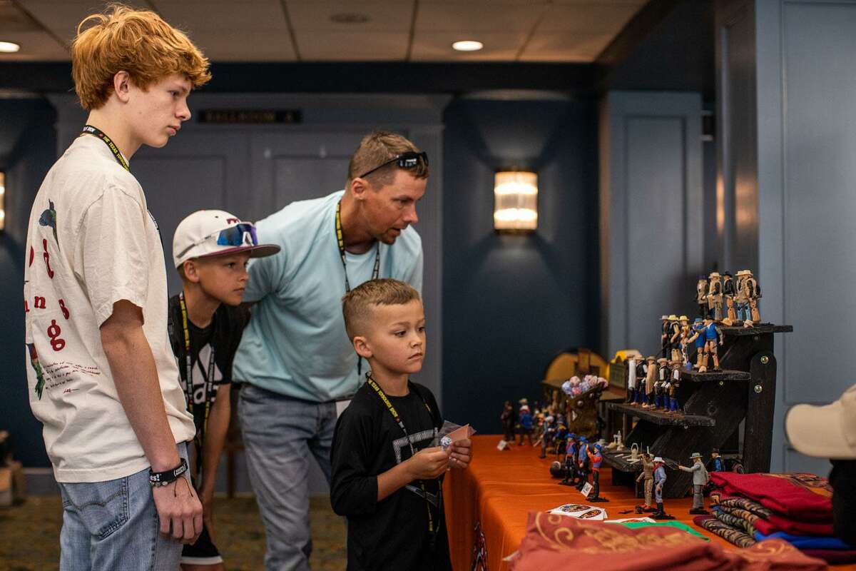 From left, Landon Lara, 17; Champ Moore, 11; Harry Moore, 43; and Christian Moore, 5, attend the Texas Toy Soldier Show on Saturday, May 21, 2022. The show made its post-pandemic return to San Antonio this weekend.