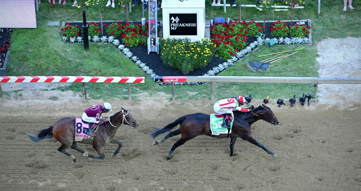 Early Voting, right, wins the 147th Preakness Stakes, outpacing favorite and Kentucky Derby runner-up Epicenter on Saturday, May 21, 2022, at Pimlico Race Course in Baltimore. (Jerry Jackson/Baltimore Sun/TNS)