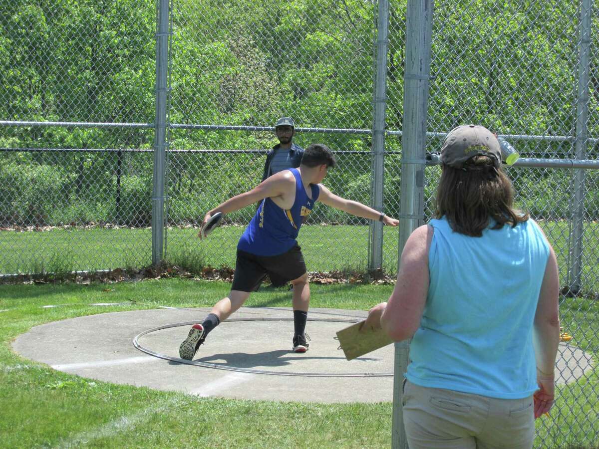 Gilbert’s Joshua Flores winds for a discus throw at Saturday’s Berkshire League Track and Field Championship Meet at Litchfield’s Plum Hill Sports Complex.