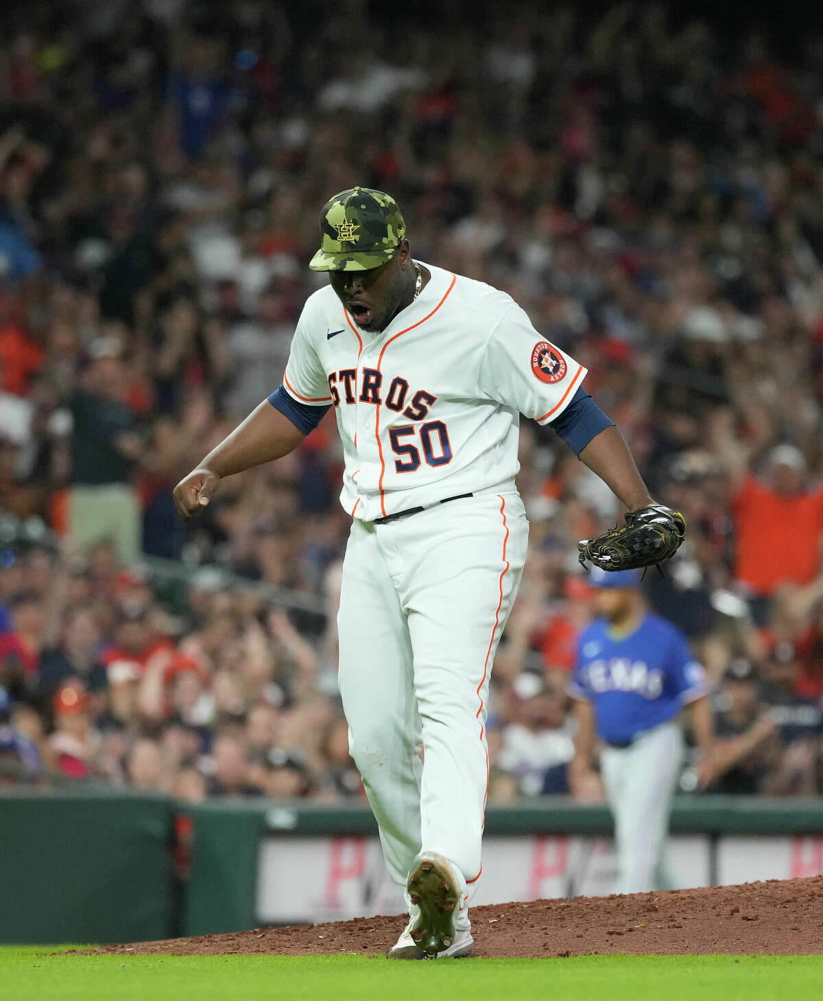Houston Astros relief pitcher Hector Neris (50) reacts after striking out Texas Rangers right fielder Kole Calhoun (56) to end the top of the eighth inning of an MLB game at Minute Maid Park on Saturday, May 21, 2022 in Houston.