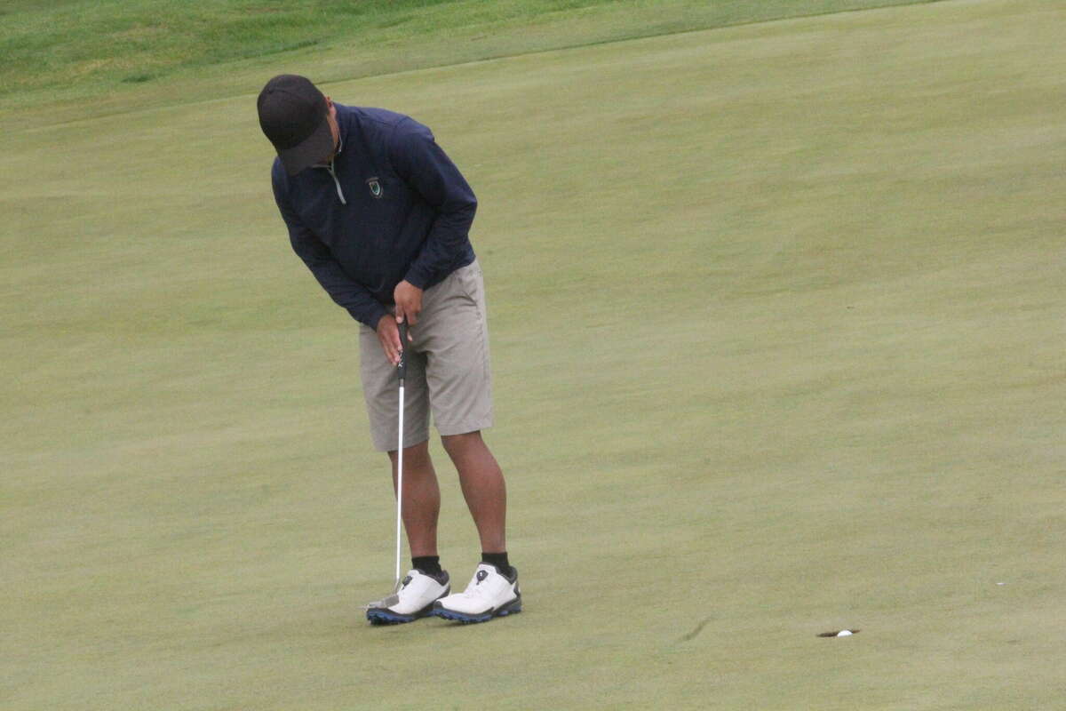 Big Rapids' Kyle Schroeder watches his putt curl into the cup at Katke Golf Course on Saturday.