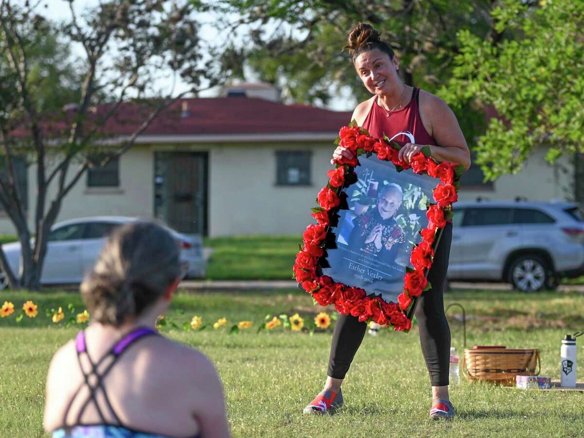 Yoga instructor Stacie Orsagh explains to her Woodlawn Lake class why she keeps a portrait fo the late Esther Vexler, known as San Antonio’s Mother of Yoga, on display. Orsagh considers Vexler a spiritual leader.