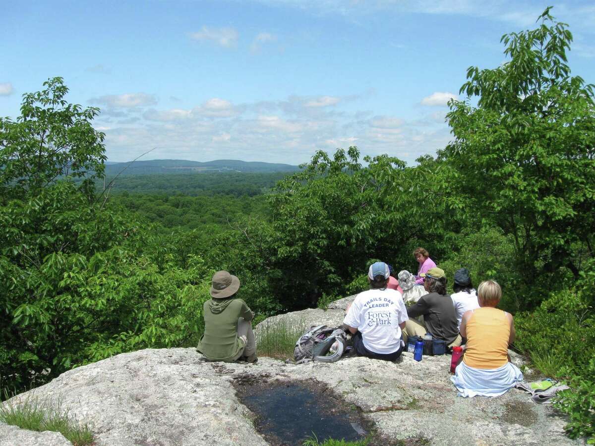 File photo of some hikers catching a break at Millers Pond State Park in Durham.