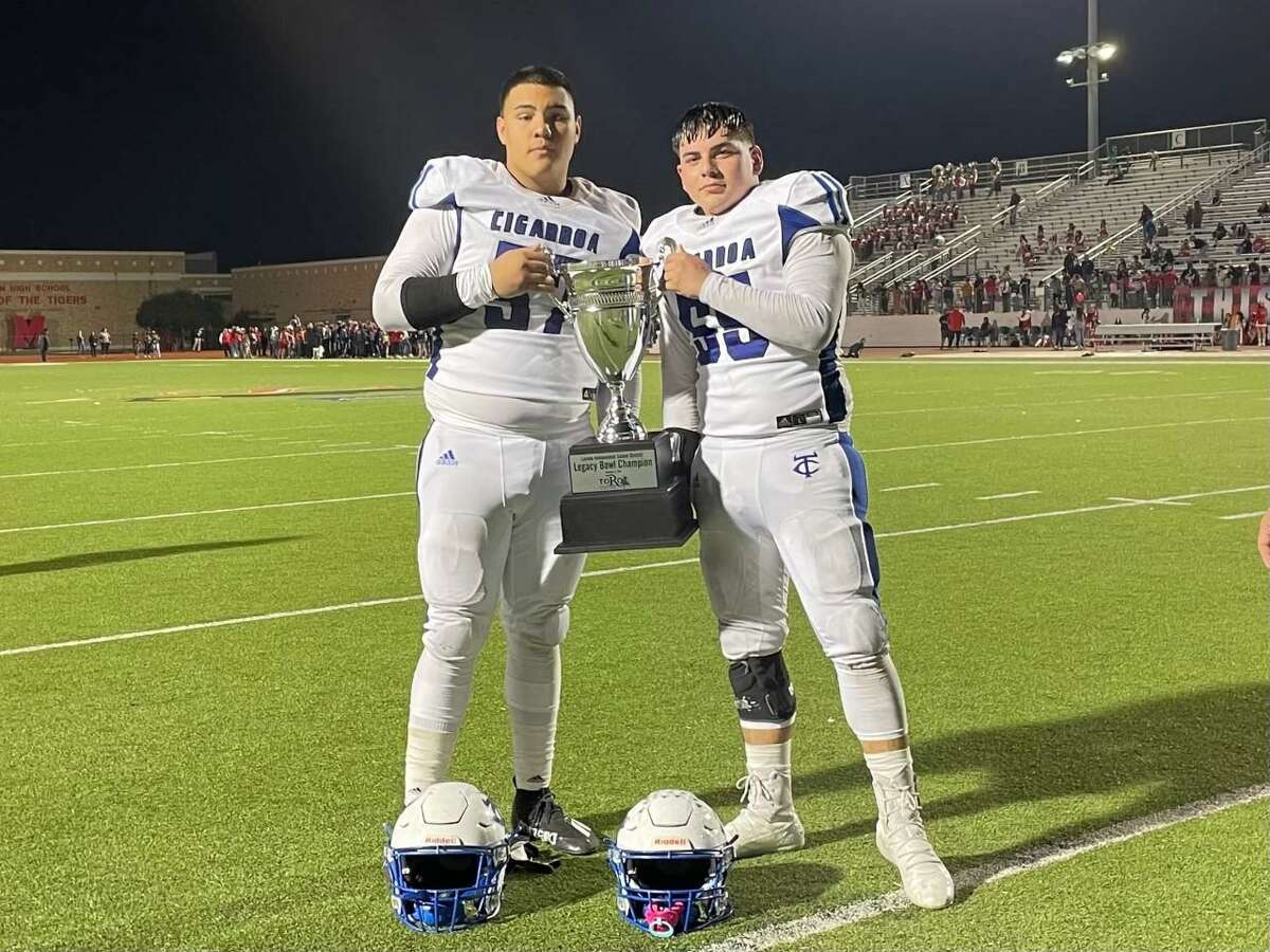 Cigarroa’s Juan Gamez and Rolando Valles pose after winning the Legacy Bowl Trophy against Martin last season. The pair will be playing in th 15th Annual All-Star Game to benefit the South Texas Food Bank and Mercy Ministries on Thursday.