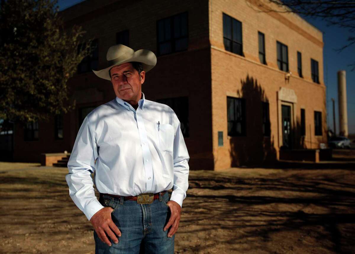 In this photo taken Feb. 18, 2011, Loving County Judge Skeet Lee Jones poses in front of the Loving County Court House in Mentone, Texas. The top elected official in a rural and sparsely populated West Texas county has been arrested after being accused of stealing cattle. Jones and three other men were arrested on Friday, May 20, 2022 on charges of livestock theft and engaging in organized criminal activity. (Sonya N. Hebert/The Dallas Morning News via AP)