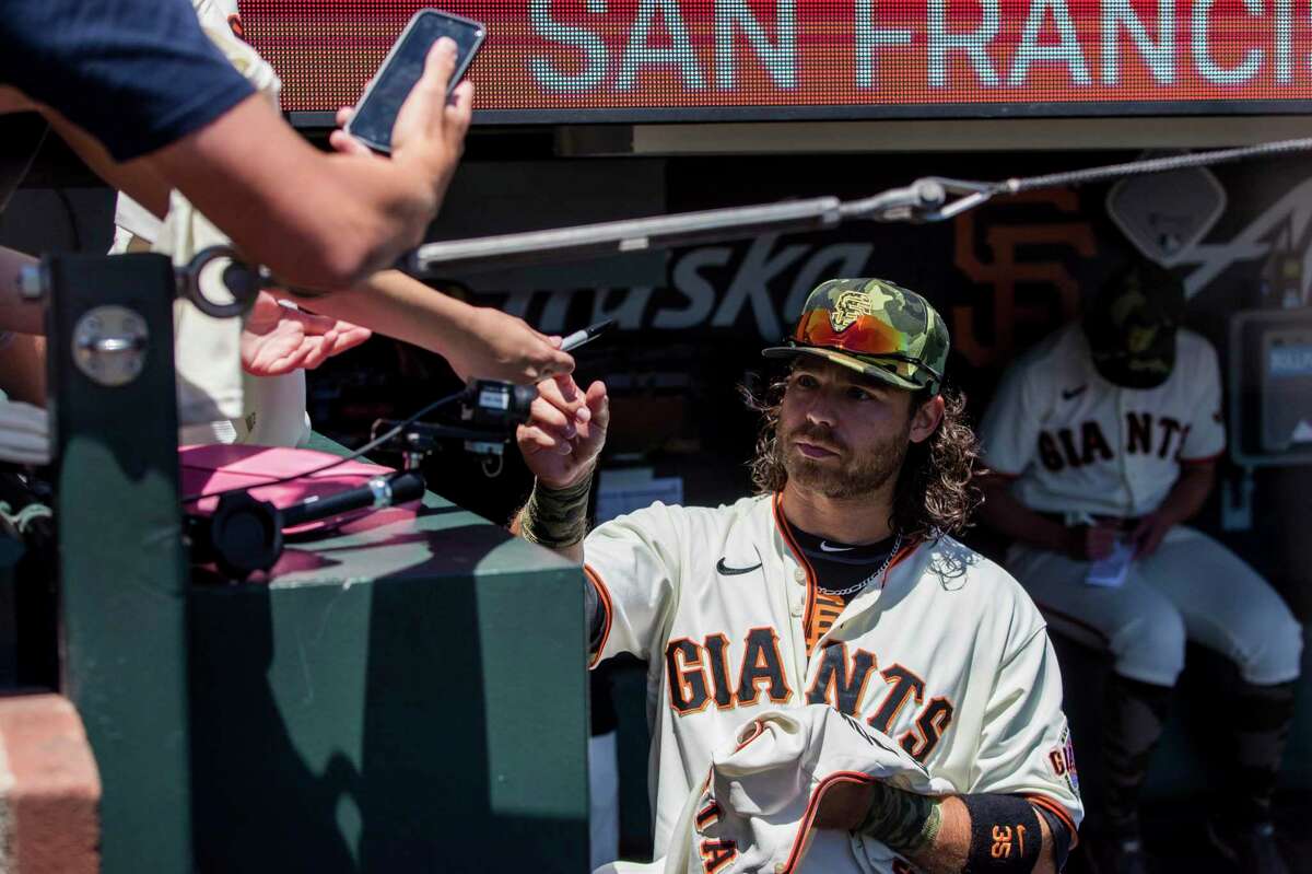 San Francisco Giants' Brandon Crawford signs autographs before a baseball game against the San Diego Padres in San Francisco, Sunday, May 22, 2022. (AP Photo/John Hefti)