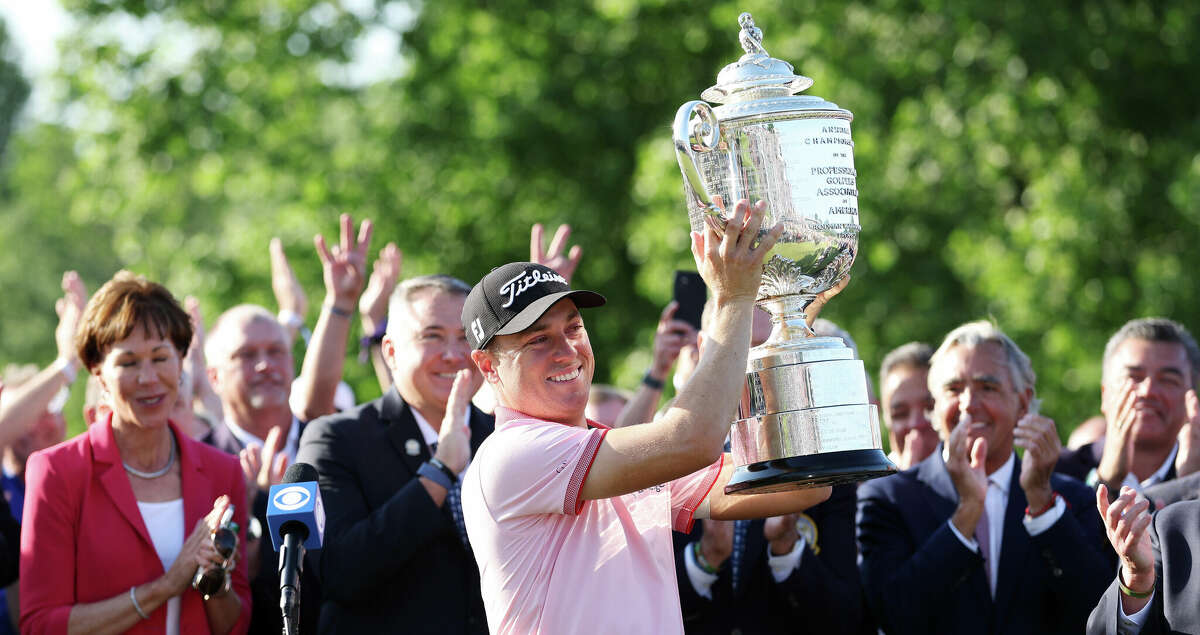 Justin Thomas of the United States celebrates with the Wanamaker Trophy after putting in to win on the 18th green, the third playoff hole during the final round of the 2022 PGA Championship at Southern Hills Country Club on May 22, 2022 in Tulsa, Oklahoma. (Photo by Richard Heathcote/Getty Images)
