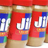 A row of Jif Creamy Peanut Butter containers.