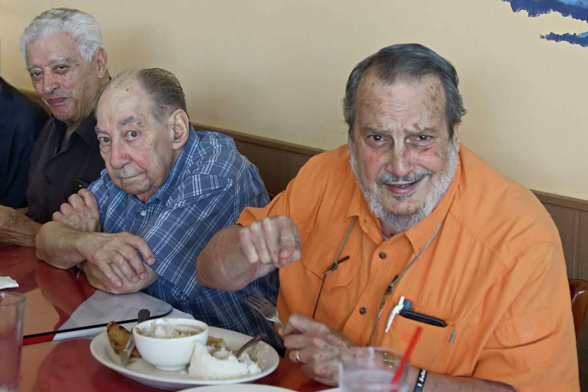 Cuban American members of the Casa Cuba Houston social organization discuss new U.S. government policies that lifted restrictions imposed by the Trump administration on the Caribbean island, at the Rincon Criollo Cuban restaurant in Houston on May 17, 2022. From left, Jose Jimenez, Francisco Arrufat and Jorge Ferragut.