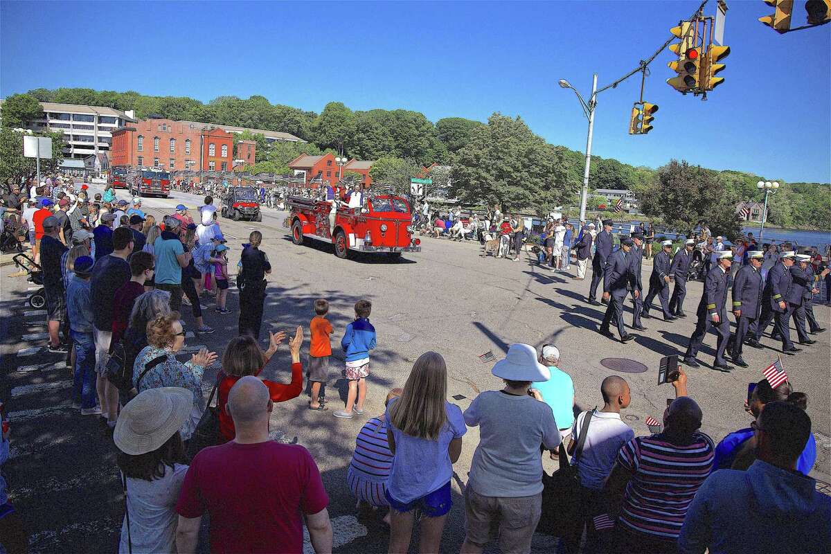 The crowd watches firetrucks crossing the Post Road bridge at the Memorial Day parade on Monday, May 27, 2019, in Westport, Conn.