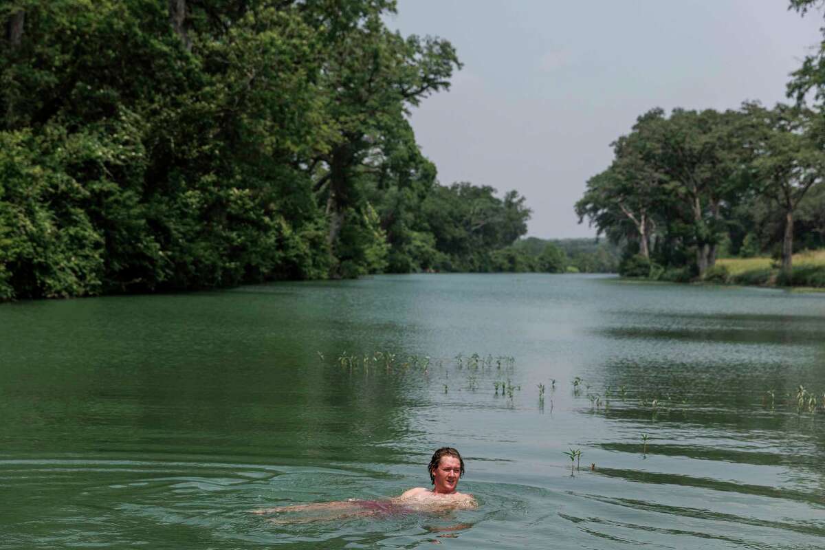 Guthrie Efferson takes a dip on May 20 in a part of the Blanco River that lies within the 533 acres of property in El Rancho Cima that The Nature Conservancy and Hays County partnered to preserve. Efferson was visiting his uncle Lon Shell, Hays County commissioner for Precinct 3, who helped secure a piece of the property for land conservation. The Nature Conservancy bought the property and sold it to Hays County, which in turn, conveyed a conservation easement to the nonprofit.