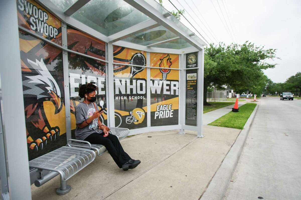 Paige Turner sits in a bus shelter designed by students at Eisenhower High School Monday, May 23, 2022 in Houston. Metropolitan Transit Authority leaders joined Aldine ISD administrators and students to celebrate the unveiling of a new bus shelter designed entirely by Eisenhower seniors.