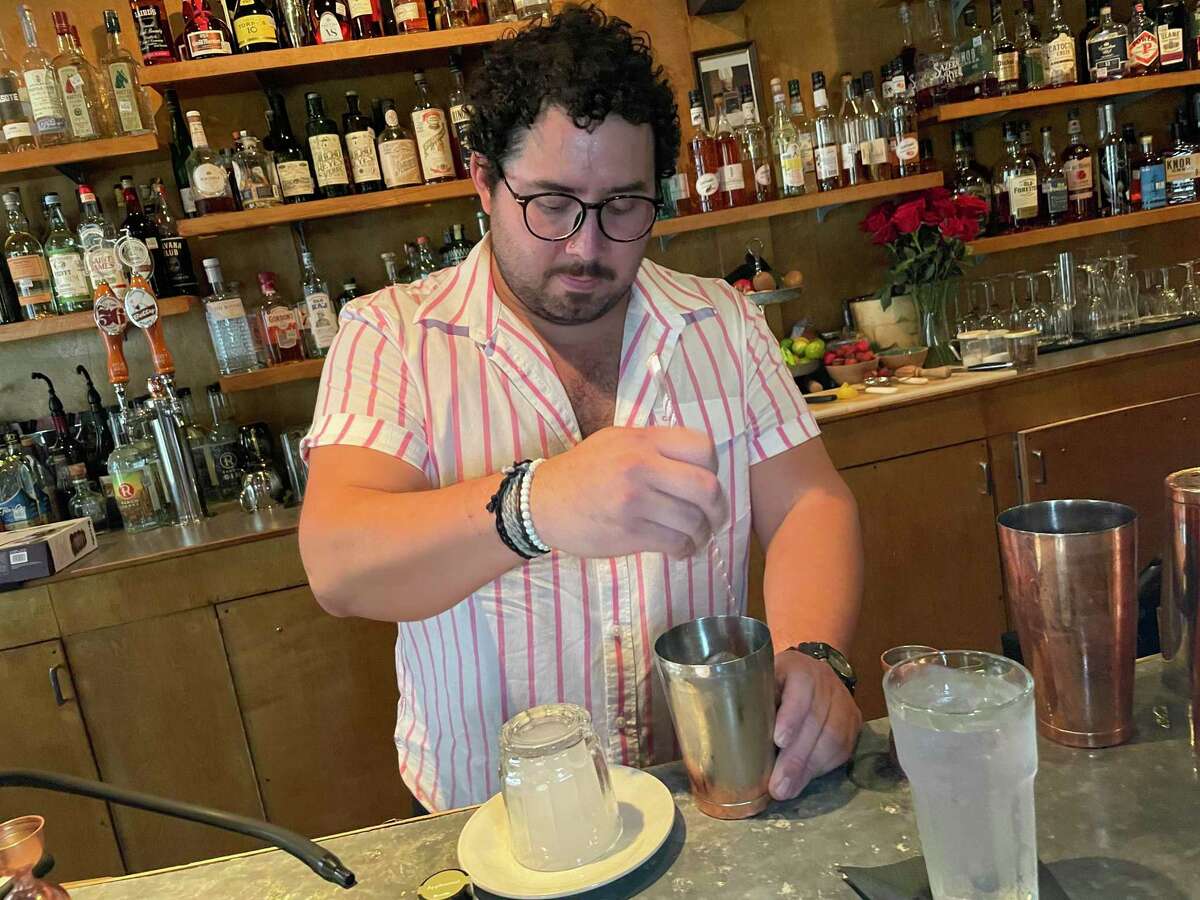 David Naylor makes a smoked gin cocktail at The Modernist in San Antonio.