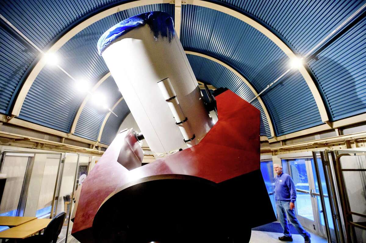 Mike Dorward, a Chabot Space & Science Center volunteer telescope operator, stands for a portrait next to the Nellie telescope on Friday, May 6, 2022, in Oakland, Calif. Nellie is a 36” reflecting telescope.
