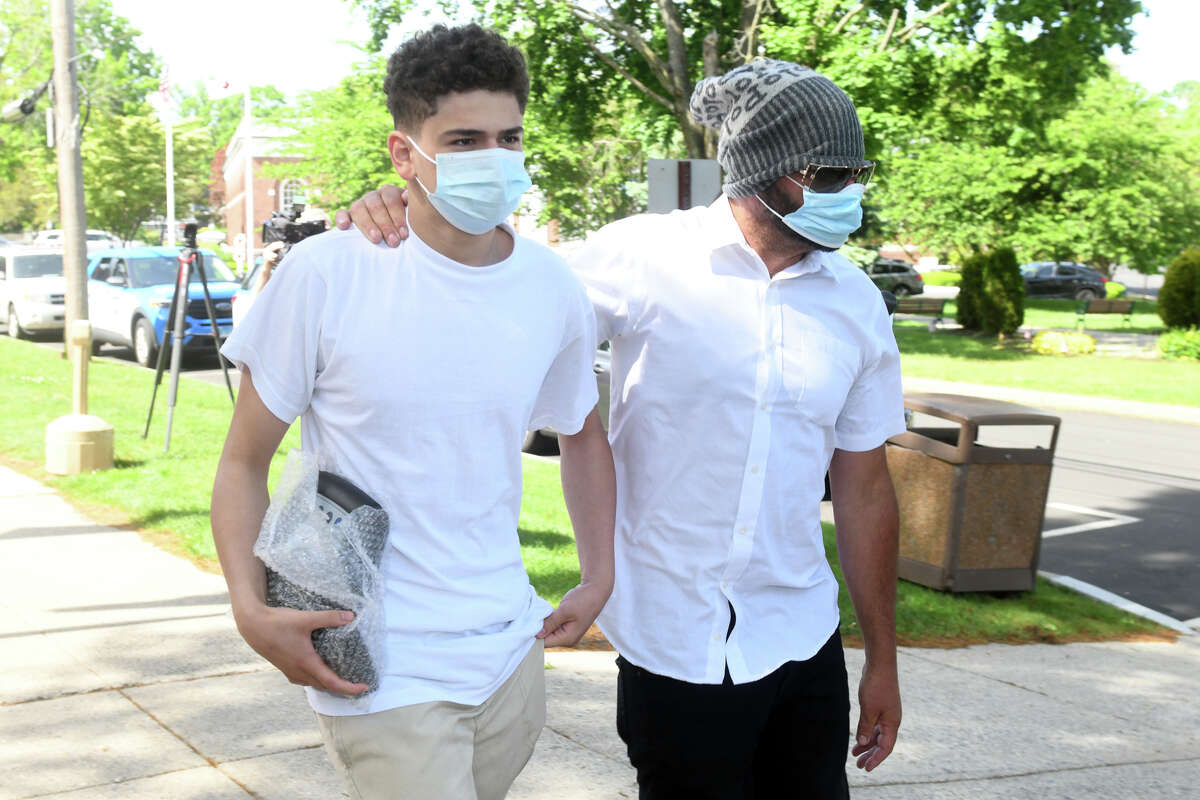 Raul Valle, left, leaves the State Courthouse in Milford, Conn. May 23, 2022.