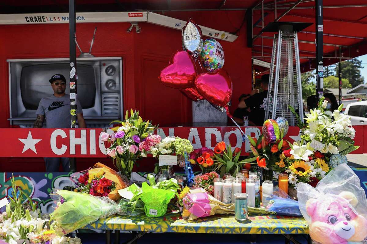Flowers at a memorial outside Lucky Three Seven on May 19 in Oakland, the day after the co-owner of the beloved restaurant was killed.